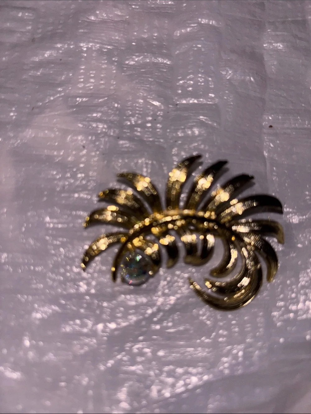 Gold Tone Floral Swirl Brooch with Iridescent Crystal